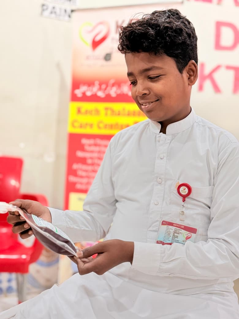 Fahad Rashid holding a blood bag at KTCC